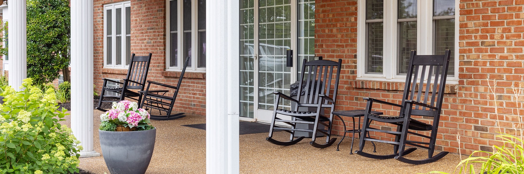 Patio with rocking chairs at Southern Oaks Post Acute